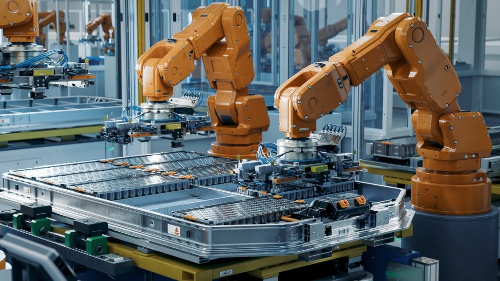 coverofadvancingcleantechnologymanufacturing rowofadvancedroboticarmsinsideautomotiveplantassemblebatteries shutterstock 2374437801